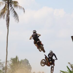 Riding dirt bikes on a challenging trail during the Bali Dirt Bike Adventure.