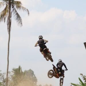 Riding dirt bikes on a challenging trail during the Bali Dirt Bike Adventure.